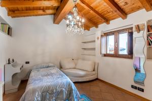 a bedroom with a bed and a chandelier at Pina's House - by Host4U in Gussago