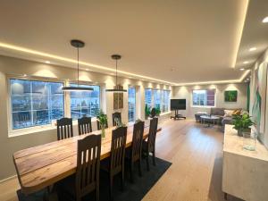a dining room and living room with a table and chairs at Penthouse apartment with amazing view. in Tromsø