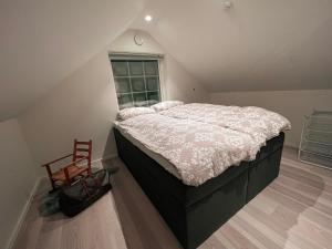 a bedroom with a large bed in a attic at Penthouse apartment with amazing view. in Tromsø