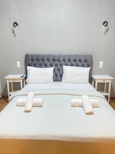 a large white bed with two pillows on it at Athens City Themis 5 in Athens