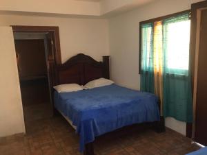 Postel nebo postele na pokoji v ubytování Buen Hombre kite Hotel y restaurante