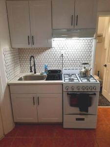 a kitchen with a stove and a sink at Pet Friendly Apartment minutes from NYC! in West New York