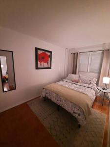 a bedroom with a bed and a mirror and a window at Pet Friendly Apartment minutes from NYC! in West New York