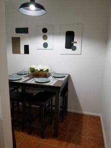 a dining room table with plates and flowers on it at Pet Friendly Apartment minutes from NYC! in West New York