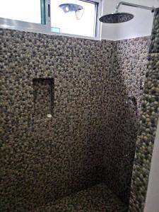 a shower with a glass door in a bathroom at La Conchita de Sisal 1 in Sisal +7 photos