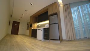 an empty room with a kitchen with a large window at Villa Misk Alkhobar in Al Khobar