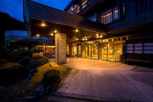 a building with a walkway in front of it at night at Hotel Kitanoya in Miyazu
