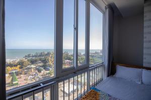 a bedroom with a bed and a view of the ocean at Sơn Thịnh - Oasky Apartment in Vung Tau