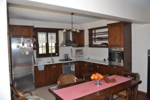 a kitchen with a table and a stainless steel refrigerator at Villa Özdilek in Sapanca