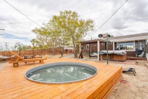 a deck with a hot tub on top of a house at Palm Vista Retreat *Hot Tub/Cowboy Pool/Hammocks* in Joshua Tree