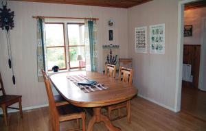 a dining room with a wooden table and chairs at 2 Bedroom Stunning Home In Skepplanda in Hålan