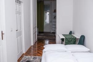 a hallway with a bed and a table and a door at Diana’s Apartment in Arad