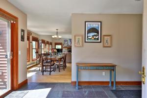 a dining room and living room with a table and chairs at Cortina Mountain Chalet - Outdoor Hot Tub - Close to Pico and Killington Mountains home in Mendon