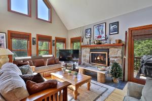 a living room with a couch and a fireplace at Cortina Mountain Chalet - Outdoor Hot Tub - Close to Pico and Killington Mountains home in Mendon