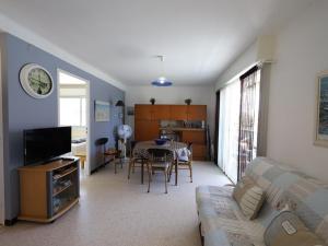 a living room with a couch and a dining room at Appartement Palavas-les-Flots, 2 pièces, 4 personnes - FR-1-559-3 in Palavas-les-Flots