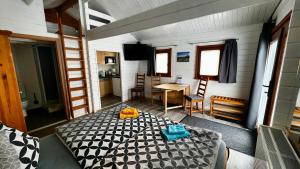 een kamer met een bed, een tafel en een keuken bij Ferienhaus Seepferdchen in Göhren