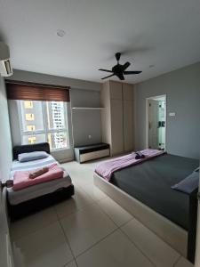 a bedroom with two beds and a ceiling fan at Mansion One, Private Room in George Town