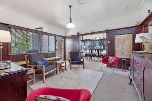 a living room with chairs and a dining room at 35 Wilson Avenue Dicky Beach QLD in Caloundra