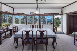 a dining room with a table and chairs at 35 Wilson Avenue Dicky Beach QLD in Caloundra