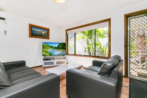 a living room with two leather couches and a tv at BIG4 Breeze Holiday Parks - Port Elliot in Port Elliot