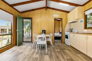 a kitchen and dining room with a table and chairs at BIG4 Breeze Holiday Parks - Port Elliot in Port Elliot
