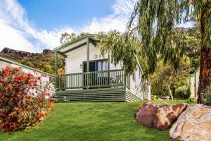 a house with a large deck and a yard at Breeze Holiday Parks - Halls Gap in Halls Gap