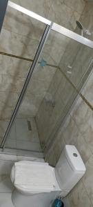 a bathroom with a toilet and a glass shower at Grand Niki Hotel & Spa in Antalya