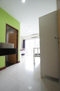 an open door to a living room with a piano at Bedbox Hostel in Patong Beach