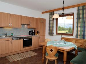 a kitchen with a table and a dining room at Apartments Filzsteinalm, Hochkrimml in Kirchdorf