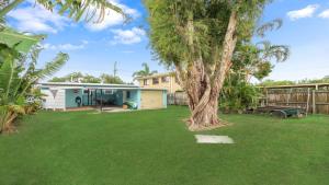a yard with a caravan and a tree at 92 Landsborough Parade Golden Beach in Golden Beach