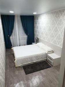 Postel nebo postele na pokoji v ubytování Apartment on Metallurgov 32