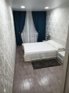 Postel nebo postele na pokoji v ubytování Apartment on Metallurgov 32