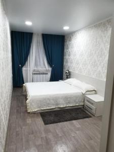 Postel nebo postele na pokoji v ubytování Apartment on Metallurgov 32