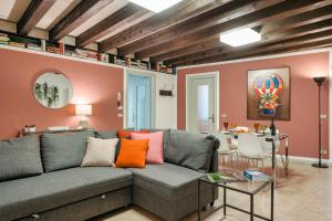 a living room with a couch and a table at Iseo Portelle Holiday with private parking in Iseo