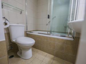 a bathroom with a toilet and a shower and a sink at Super OYO Capital O 907 Ceo Flats in Manila