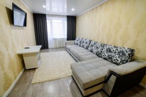 a living room with a couch and a table at Квартира in Temirtaū