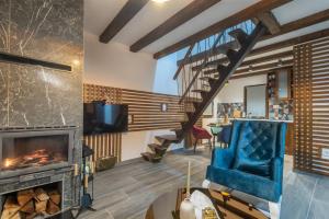 a living room with a fireplace and a staircase at Mila house Tara in Bajina Bašta