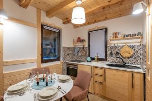 a kitchen with a table and chairs and a sink at Mila house Tara in Bajina Bašta