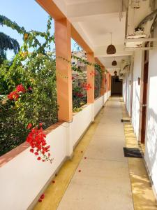 an empty corridor of a school building with flowers at Esprit d'Ici Hotel in Mirissa