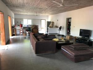 a living room with a brown couch and a table at Villa Soa in Hell-Ville