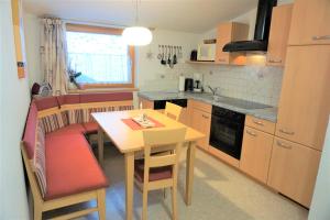 a kitchen with a table and a dining room at Stallhäusl in Schladming +34 photos