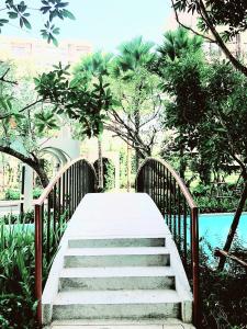 a stairway leading to a bridge over a pool at New. Beautiful One Bedroom Pool Access Condo. Only 200 metres to the beach. in Hua Hin