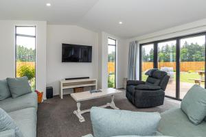 a living room with two couches and a tv at Just like home - Methven in Methven