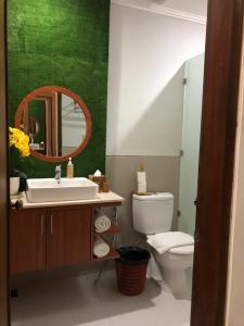 a bathroom with a sink and a toilet and a mirror at Dewi Dewi Villas in Sanur