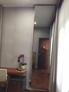 a room with a desk and a door and a table at Dewi Dewi Villas in Sanur