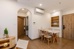 a kitchen and dining room with a table and chairs at Ecopark - Lullaby Home Ecopark in HÆ°ng YÃªn