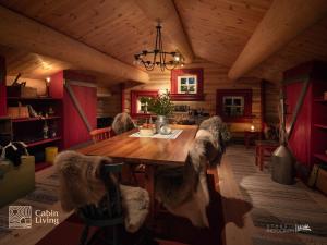 a dining room with a wooden table in a cabin at Large cabin on Nesfjellet pure luxury feeling in Nes i Ådal