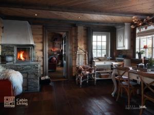 een woonkamer met een open haard en een eetkamer bij Large cabin on Nesfjellet pure luxury feeling in Nes i Ådal