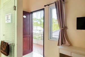 a door with a window in a room at Fabel Homestay in Palembang