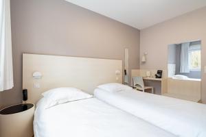 Ένα ή περισσότερα κρεβάτια σε δωμάτιο στο Hôtel Vulcain